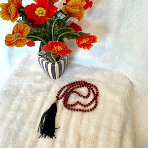 Zen 🧘🏻‍♀️ Dark red and gold beaded necklace with fluffy black tassel.